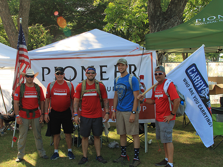 Group of men in red Pioneer shirts