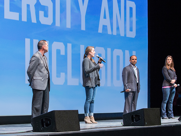 People on a stage giving a presentation