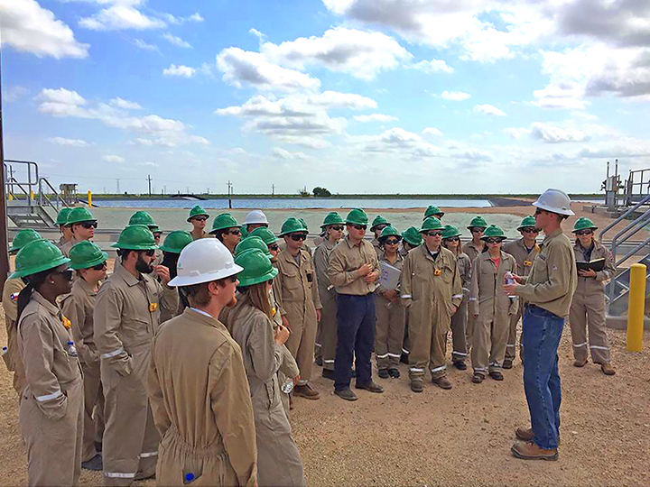 Large group of people in hard hats