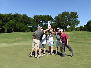 People high fiving on the golf course